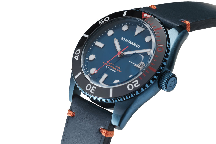 Stalingrad Volga defender automatic watch with a blue case and blue  dial with orange second hand in a blue leather strap, diagonal view or watch on a white background