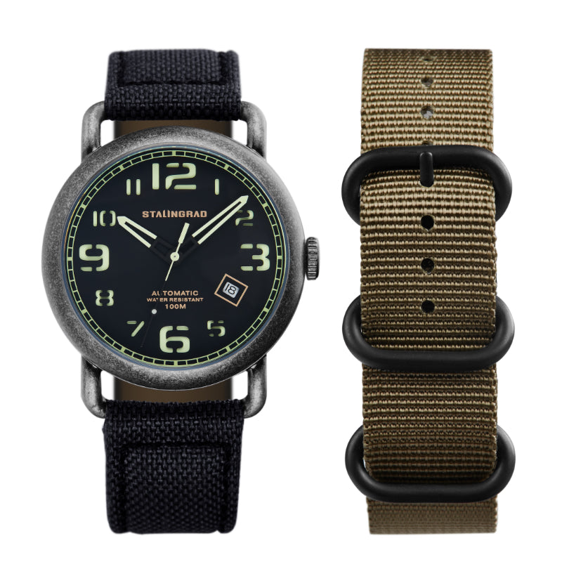 Stalingrad Rodim Watch with a sandwich dial. Black and green dial, black case and a black cordura strap, front view of watch on white background.